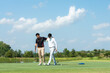 © freebird7977 - Group golf professional Golfer asian man walking in fairway with bag golf at golf  club.  Hobby in holiday and vacation with friends.  Lifestyle and Sport Concept