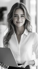 Wall Mural - Woman with long hair, smiling, holding a tablet or laptop, wearing a white shirt, standing in a modern setting