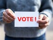 © Steveandfriend - A person holds a card with the word 'VOOT' in bold red letters, showcasing modern communication and branding concepts.