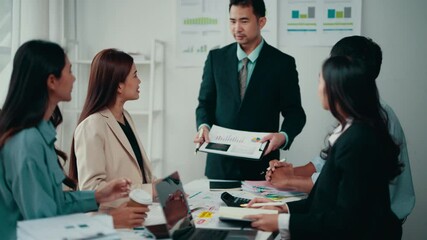Poster - Diverse team collaborating in office setting, enthusiastically discussing sales charts on presentation board, fostering creativity and strategic planning