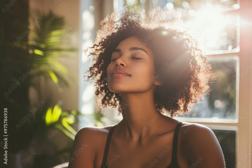 Serene young woman with eyes closed taking a deep breath of fresh air ...