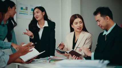 Aufkleber - Team of four asian businesspeople are discussing financial data. One woman is calculating numbers while the others are analyzing reports and brainstorming solutions