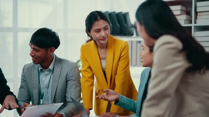 Poster - Young businesswoman in a yellow blazer leads a productive brainstorming session, engaging a diverse team of colleagues in discussion and collaboration to generate innovative ideas