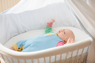 Little baby on white bed