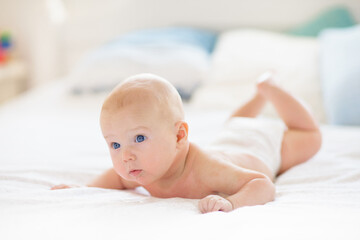 Wall Mural - little baby on white bed