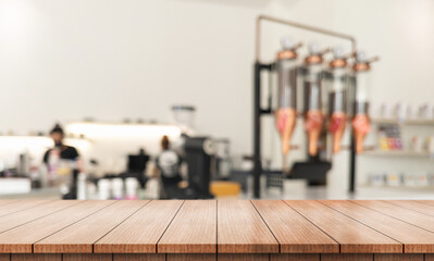 Wall Mural - Empty wooden table top with bokeh lights in a blurred restaurant background.