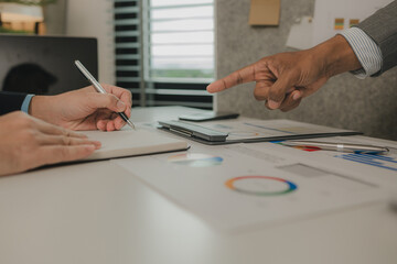 two businessmen are having a meeting and discussing the content of an important paperwork, there is a discussion between the businessman and his business partner, teamwork, workplace