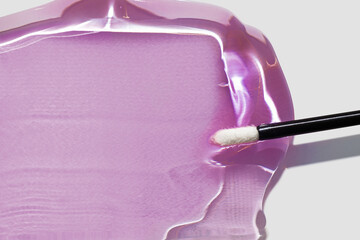 pink fuchsia transparent lip gloss or oil lip care moisturizer swatch smudge with applicator brush o