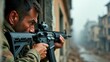 © SerPak - A soldier is aiming a rifle out of a broken window in an urban warzone, highlighting the tense and dangerous environment of active military conflict with buildings in the background.