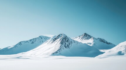 Wall Mural - Snow-covered mountain peaks under a clear blue sky, with fresh powder waiting to be explored.