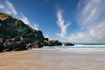 Scenic Beach with Rocky Cliffs and Blue Sky at Mawgan Porth Beach, Newquay, Cornwall