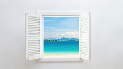 A serene view of a tropical beach through an open window, showcasing clear blue water and distant mountains under a bright sky.