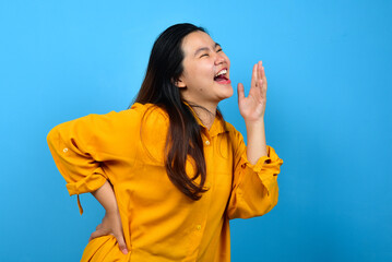 happy asian woman laughing out loud. excited beautiful woman feeling joy on isolated on blue background