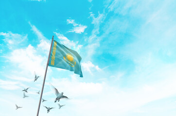 Kazakhstan flag waving with flying doves in beautiful sky. Kazakhstan flag for Republic Day and Independence Day.