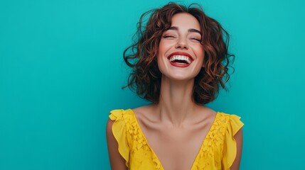 Wall Mural - Young woman laughing with curly hair, wearing yellow dress, against a teal background.