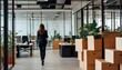 © VexoraImages - Businesswoman walking through modern office with moving boxes