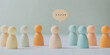 © Taskmanager - A group of colorful wooden figurines standing together with a speech bubble above them, representing teamwork, communication, and community discussions.