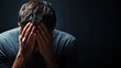 © Nima - A man with his head bowed down, hands covering his face, conveys deep sadness, stress, and a sense of hopelessness. He symbolizes emotional pain, despair, and the need for solace.