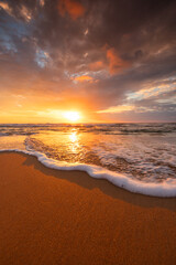 Poster - Scenic sunrise over sea splashing waves on the beach, exotic ocean shore sunset vertical view