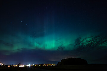 Wall Mural - northern lights dancing over the sky sky in the country road