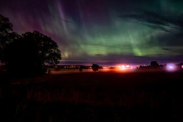 Wall Mural - northern lights dancing over the sky sky in the country road