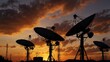 © Kasper - Satellite dishes or antennas silhouetted against a dramatic sunset.