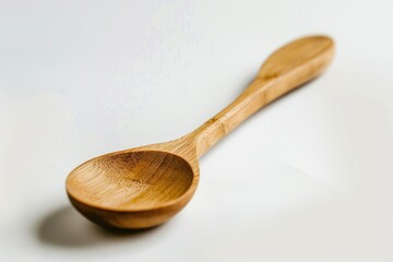 Poster - A simple wooden spoon rests on a flat surface