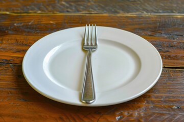 A simple table setting with a white plate and two utensils, perfect for everyday meals or special occasions