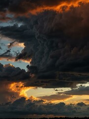 Canvas Print - Time lapse from orange sunset to dark clouds.