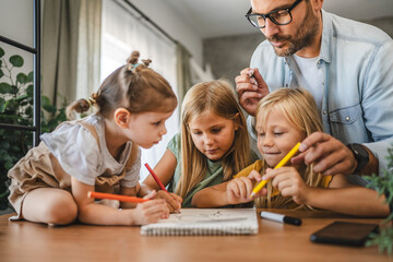 Adult single father of three daughters help them to do homework