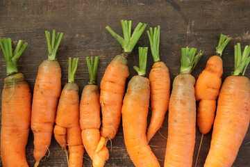 Fresh carrots on a wooden background. Autumn harvest.