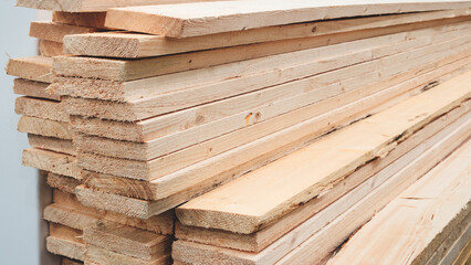 Poster - A stack of wood planks with some of them being cut. Concept of hard work and dedication