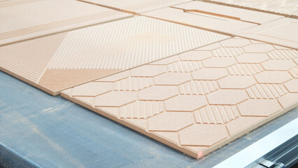 Poster - A wooden board with a pattern of hexagons and squares is being cut by a machine. The board is being used for a project, and the machine is cutting it into pieces