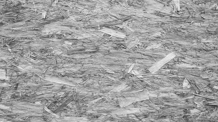 Poster - A grey background with wood chips scattered across it. The wood chips are of different sizes and shapes, creating a textured and natural look. Concept of rustic charm and warmth