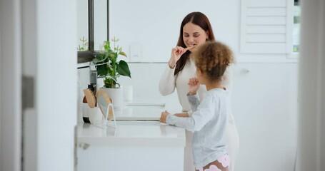 Wall Mural - Oral, dental care and a family brushing teeth in the bathroom of a home together for morning routine. Toothbrush, toothpaste or hygiene with a mom and daughter cleaning their mouth in an apartment