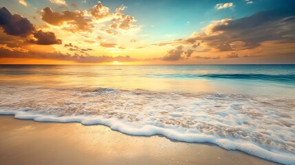 Wall Mural - Beautiful sunset over a calm ocean with foamy waves lapping at the sandy shore.