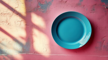 Poster - Turquoise plate on textured pink wall, artistic decor. Creative color contrast concept