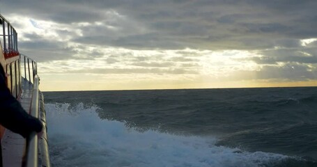 Wall Mural - Stormy boat trip with cutter, hand on railing, Strait of Magellan, Patagonia, Chile, South America