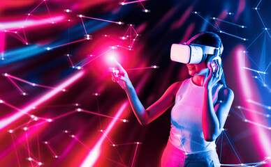 Wall Mural - Smart female standing in cyberpunk style building in meta wear VR headset connecting metaverse, future cyberspace community technology, Woman use finger touching virtual reality object. Hallucination.