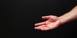 © gunzexx png and bg - A single extended hand with an open palm stands out against a stark black background, symbolizing gesture, communication, and the offering of help or need for connection.