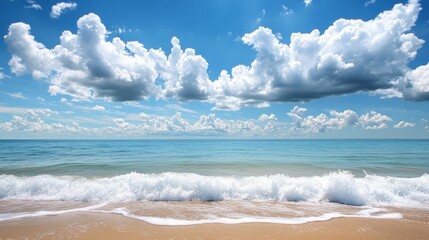 Canvas Print - Capture a tranquil beach setting with large, puffy clouds dotting the sky, and gentle waves rolling onto the shore, providing a picturesque and soothing view