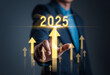 © Kampan - Happy new year 2025 hand touch on a virtual screen 2025. New Goals, Plans, and numbers for Next Year. Businessman touching future growth year 2024 to 2025. Planning, opportunity, business strategy
