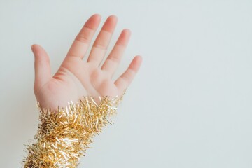 Aufkleber - Hand in Golden Tinsel Sleeve with Symmetrical Abstract Blur on White Background - High-Definition Festive