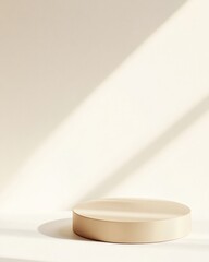 Poster - Minimalist Soft Gold Round Podium on White Background with Delicate Shadows and Modern Monochromatic Aesthetic