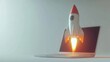 © ShinneProject - A white toy rocket launches from a laptop screen, representing business growth and innovation.