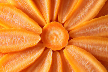 Close-up photo of a bright orange carrot sliced in a flower shape.