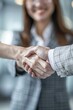 © fanjianhua - A woman in professional attire shaking hands