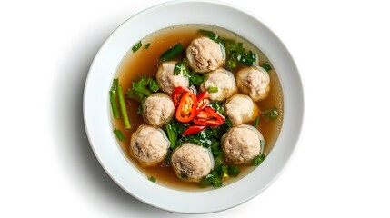 Wall Mural - Delicious meatball soup with fresh herbs and sliced red chili on white background