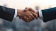 © Phirakhup - A close-up of two business professionals shaking hands in a corporate setting, symbolizing partnership and agreement.