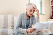 © Malambo/peopleimages.com - Senior woman, stress and paper for finance in home, laptop and online mistake for payment. Female person, asset management and website to review mortgage interest, frustrated and insurance form fail